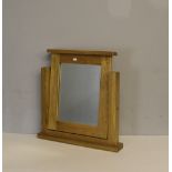 A modern oak dressing mirror, slightly pivoting between plain supports 57cm x 51cm good condition.