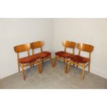 A set of four mid-century laminate backed dining chairs, unmarked but in the manner of Dyrlund