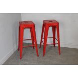 A pair of red-painted metal bar stools, of vintage design 67cm some minor marks generally in good