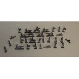 A collection of cast-lead model soldiers, unpainted.