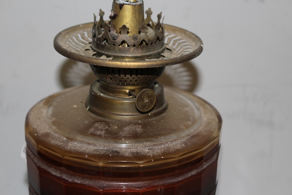 A Victorian brass and glass oil lamp, with brass burner over the amber glass reservoir and barley- - Image 3 of 4