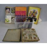 An Edwardian scrap book, two mid 20th century scrap books and a collection of various postcards