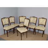 A set of six French mahogany dining chairs, with foliate carved crest and seat rails, padded backs