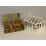 A doll's house garden setting and green house, with a variety of associated items, furniture, garden