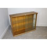 A vintage teak-effect laminate bookcase with sliding glass doors and glass shelving 79cm x 107cm x