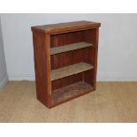 A 19th century stained pine bookcase, converted from a cupboard with doors lacking, rudimentary