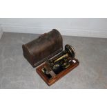 An antique Singer oak-cased hand-crack sewing machine 13674119, marks to case, some paint losses