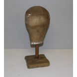 An early 20th century wig stand, 42cm high damage to base.