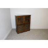 An Old Charm style oak two tier bookcase with four leaded style glass doors 110cm x 92cm x 32.5cm