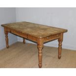 A modern pine farmhouse kitchen table, of rectangular form with single drawer to one end and