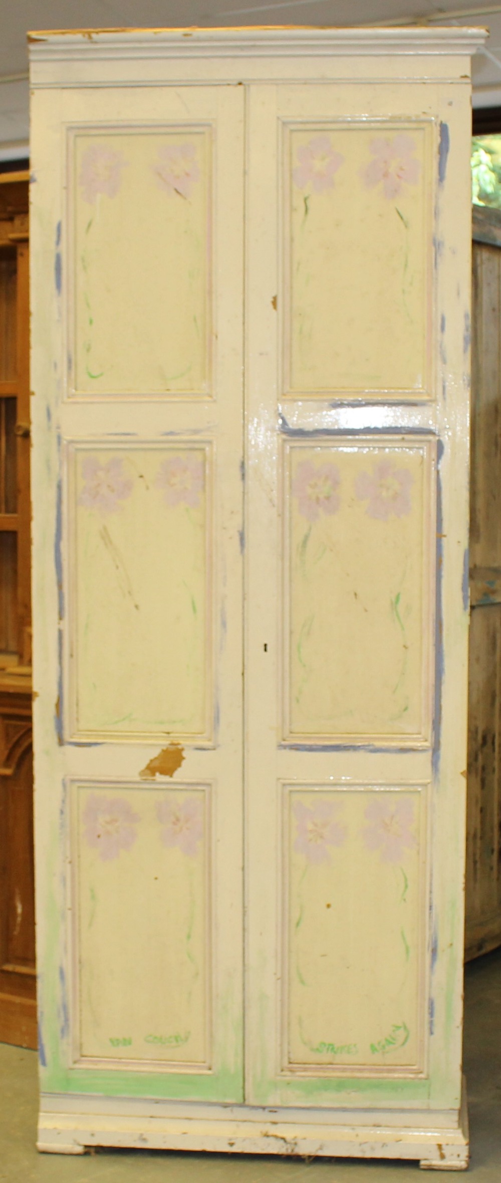 A large 19th century painted pine cupboard, with two triple panelled doors enclosing the internal