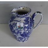 A Wetheriggs Pottery water jug, decorated with foliate and butterfly design, stamped to base 24cm