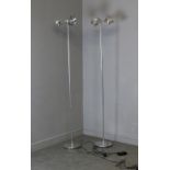 A pair of modern tall chromed coloured metal standard lamps, each head with three adjustable lights,