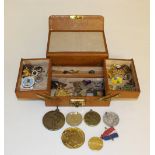 A small concertina jewellery box, containing various badges, medallions, coins etc, good condition.