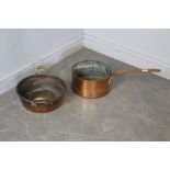 A large 19th century copper pan, with long attached copper handle 15cm x 28cm diameter together with