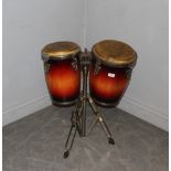 A pair of Bongo drums with metal stand, well used condition with corrosion to metal parts,