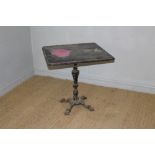 A cast-iron bar table with moulded square top over the central column and quatre-foil base 70cm x