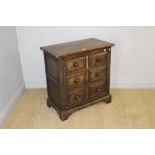 A reproduction oak chest of three drawers, the rectangular top above three drawers, panelled to