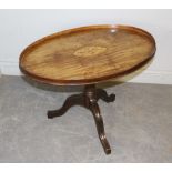 A George III mahogany tray-top table, the oval top with shallow gallery and central conch-shell