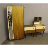 A 1960's laminate teak effect three-piece bedroom suite, comprising a single door wardrobe 166cm a