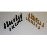 An antique turned boxwood and ebonised/stained wood chess set, thirty two pieces in total, knights