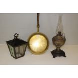 A Victorian embossed copper and cast-iron 'Miller' oil lamp, a glazed iron lantern and a brass