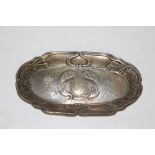 A small Art Nouveau silver dish embossed with peacocks, foliate and sinuous scrolls, rubbed marks