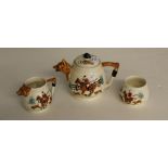 A vintage relief moulded and painted hunting theme three piece teaset, comprising a teapot, sugar