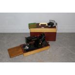 A vintage Singer electric sewing machine, model number EM 313678, with small branded box of