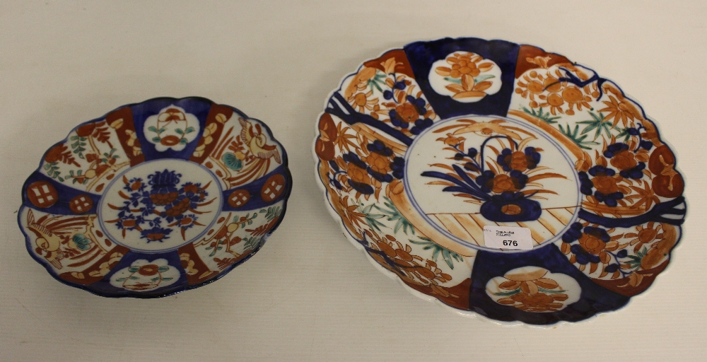 A Japanese Imari porcelain plate, decorated in the typical Imari style and palette 31cm together