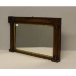 A small rosewood framed over-mantel mirror, of rectangular for m with gilt slip and three-quarter