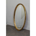 A modern oval gilt-framed mirror, with bevelled plate 97cm x 51cm good condition.