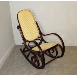 A modern reproduction 'bentwood' rocking chair, of traditional design with caned back and seat