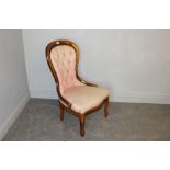 A modern deep-buttoned spoon-back nursing chair, with studded patterned pink upholstery 92cm some