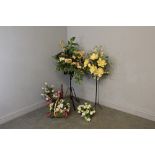 Five artificial flower displays, including two wrought-iron style stands