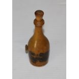 A Mauchline ware 'Auld Brig O Doon' bottle form tape measure, marked 'Bought in The cottage' to