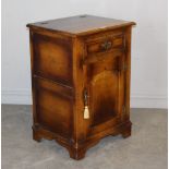 A reproduction oak media cabinet, of 17th century design with hinged lift-up top over a fielded