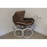 A Wilson 'Silvercross' coach built pram, in mushroom brown with canopy and cover, a tin of