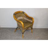 A cane and green-stained woven-wicker armchair, 84cm x 65cm some minor scuffs and damage to wicker.
