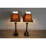 A pair of modern cast-resin electrical table lamps, with tassled tapering shades over lapet and