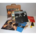 A small selection of LP records, Status Quo, John Denver, Clannad etc, housed in a leatherette
