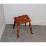 A 19th century stained beechwood milking stool, with four turned legs 34cm x 30.5cm x 23cm split