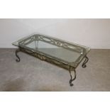 A modern metal framed and tempered glass topped coffee table, of rectangular form, the bevelled