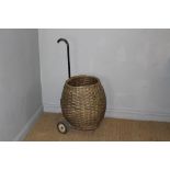 A vintage type woven-wicker and metal framed shopping trolley 102cm minor damage to wicker, paint