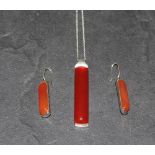 A 925 grade white metal and carnelian pendant suspended by a fine linked 925 chain, and together