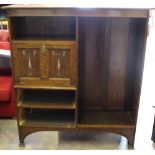 An Art Nouveau oak bookcase, with inlaid fall-front cupboard section, 150cm x 135cm x 37cm drawers