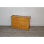 A modern teak effect two door cupboard 61cm x 92cm x 39cm