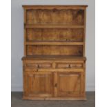 A panelled pine single piece dresser by Tucan, 124cm wide x 54cm deep x 182cm high, slight surface