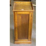 A Victorian oak bedside cabinet, with shallow raised three-quarter gallery above a long panelled