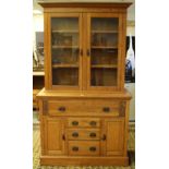 An Edwardian oak secretaire bookcase, having a moulded cornice above two glazed doors, enclosing the